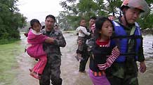 People are helped to transfer to safe places in Yingde City, south China's Guangdong Province, May 7, 2010. Heavy rainstorm hit Guangdong Province from Wednesday has left six people dead and three others missing up to 1:00 PM local time on Friday and over 50,000 people have been transferred to safe places.