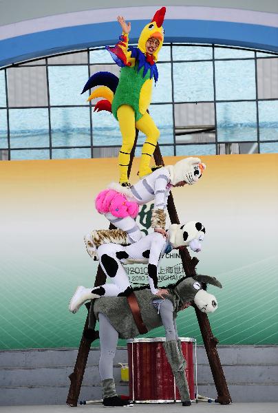 Members of the Dalian acrobatic troupe perform German fairy tale &apos;Bremer Stadtmusikanten&apos; (Bremen&apos;s city musicians) in the Bremen Pavilion at the 2010 World Expo in Shanghai, east China, May 7, 2010.