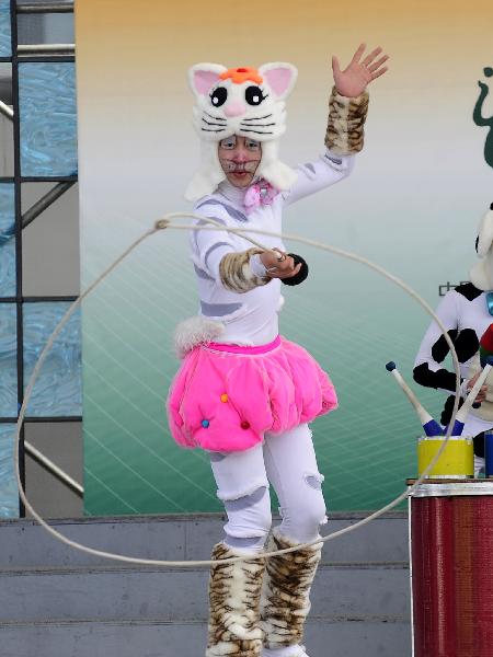 A member of the Dalian acrobatic troupe performs German fairy tale &apos;Bremer Stadtmusikanten&apos; (Bremen&apos;s city musicians) in the Bremen Pavilion at the 2010 World Expo in Shanghai, east China, May 7, 2010.