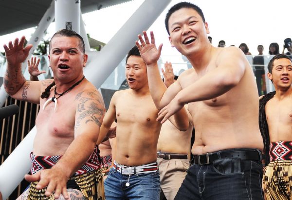 Visitors learn to dance from a Maori dancer (L1) of the New Zealand Pavilion at the World Expo Park in Shanghai, east China, May 8, 2010.