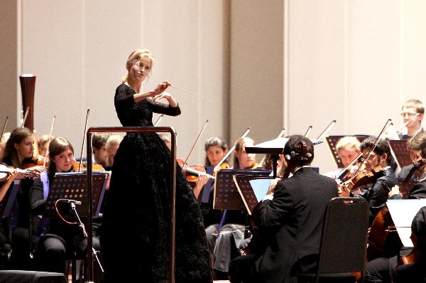 A Spanish conductress conducts a band during a concert held to mark the European Day at the 2010 World Expo in Shanghai May 9, 2010.