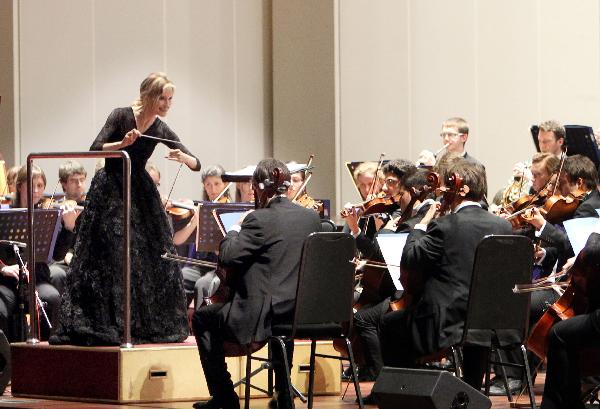 A Spanish conductress conducts a band during a concert held to mark the European Day at the 2010 World Expo in Shanghai May 9, 2010.