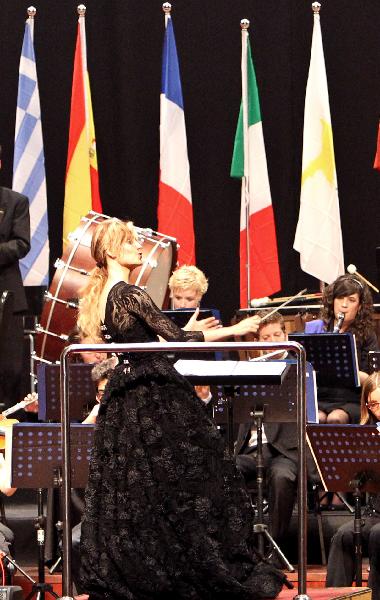 A Spanish conductress conducts a band during a concert held to mark the European Day at the 2010 World Expo in Shanghai May 9, 2010.