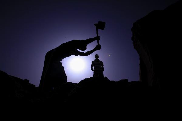 A Palestinian man digs in sands to extract gravels in Beit Lahia town northern Gaza strip, on May 9, 2010. Israel&apos;s embargo on construction materials supply into Gaza has forced Palestinians to seek alternative sources.