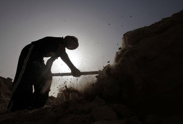 A Palestinian man digs in sands to extract gravels in Beit Lahia town of northern Gaza strip, on May 9, 2010. Israel&apos;s embargo on construction materials supply into Gaza has forced Palestinians to seek alternative sources.