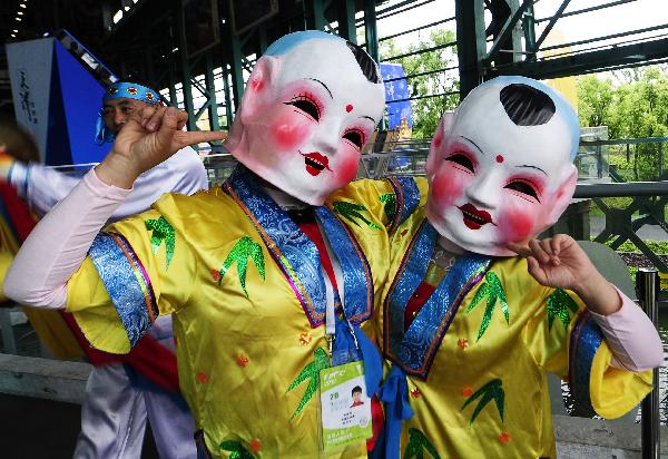 Performers wearing masks greet visitors during the 2010 Expo Tianjin Week at the 2010 World Expo in Shanghai, east China, May 9, 2010.