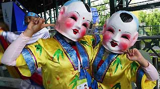 Performers wearing masks greet visitors during the 2010 Expo Tianjin Week at the 2010 World Expo in Shanghai, east China, May 9, 2010.