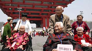 Three centenarians (on wheelchairs), whose cataract disease was cured with the support of the Life and Sunshine Pavilion, visit the China Pavilion on Monday.