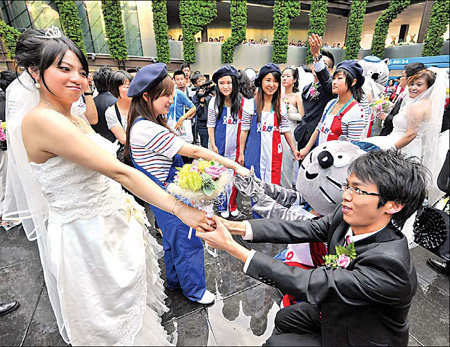 A French-style Expo group wedding ceremony is held in the Expo Garden on Tuesday.