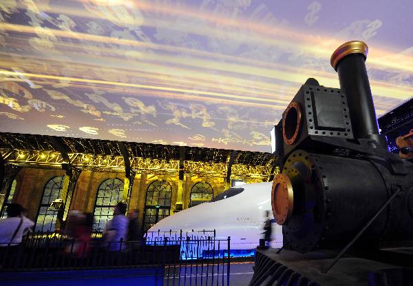 Visitors look at a train exhibited at the Pavilion of City Being in World Expo Park in Shanghai, east China, May 11, 2010.