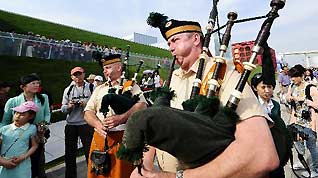 Members of a military band perform bagpipes in front of the Ireland Pavilion in the World Expo park in Shanghai, east China, May 11, 2010. The military band will perform for visitors in Shanghai from May 9 to 12.