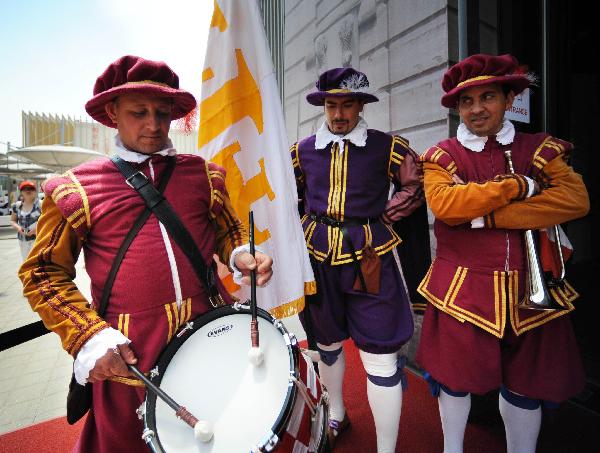 Men dressed as ancient knights stand in front of the Malta Pavilion in the World Expo Park in Shanghai, east China, May 11, 2010. 