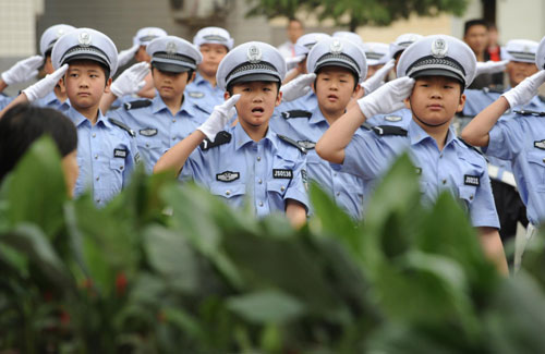 Children practise routines while dressed in traffic police uniforms in Zhengzhou, Henan Province May 17, 2010.
