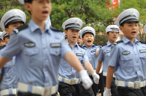 Children practise routines while dressed in traffic police uniforms in Zhengzhou, Henan Province May 17, 2010.