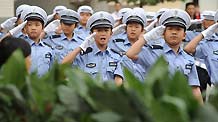 Children practise routines while dressed in traffic police uniforms in Zhengzhou, Henan Province May 17, 2010.