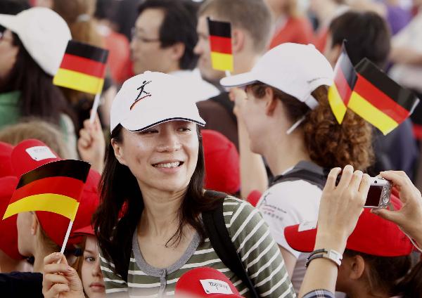 A visitor poses for a photo during the celebration marking the National Pavilion Day for Germany at the World Expo park in Shanghai, May 19, 2010