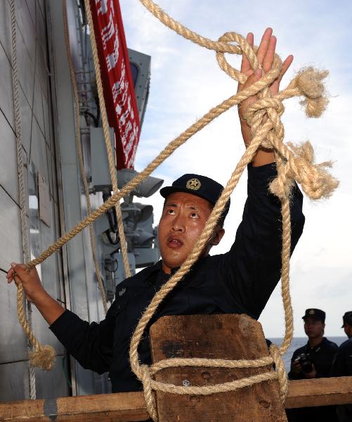 Chinese Navy soldiers exercise on the deck of destroyer DDG-168 Guangzhou during their escort mission in the Gulf of Aden, May 18, 2010.