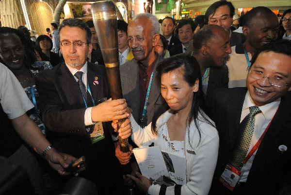 Nadir Merah (L2, front), rotating Curator of the Africa Joint Pavilion and Africa Union commissioner general for the World Expo, poses with Shanghai citizen Zhang Gennan (R2, front), the 1 millionth visitor to the Africa Joint Pavilion in World Expo park in Shanghai, May 19, 2010. Visitors to the Africa Joint Pavilion reached 1 million Wednesday.