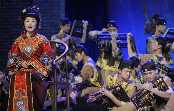 Singer Liu Wentao and dancers from Shanxi perform on the Baosteel Stage at the 2010 World Expo in Shanghai, east China, May 20, 2010.