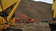 Excavators are seen at a construction site of a green agricultural base in Jiegu Town of quake-hit Yushu Tibetan Autonomous Prefecture in northwest China's Qinghai Province, May 21, 2010.
