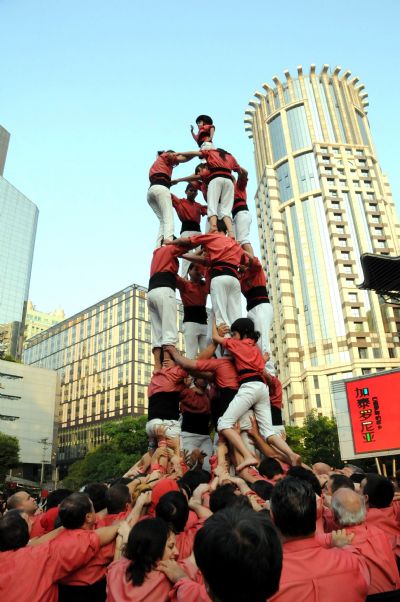 Performers from Spain stack themselves up during the Castell (means castle in Catalan) performance in the Nanjing Pedestrian Street of Shanghai, east China, May 23, 2010. The Castell performance, a traditional folk celebration in Catalonia of Spain, will also be shown in the Expo Park from May 24 to 30.
