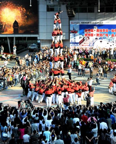 Performers from Spain stack themselves up during the Castell (means castle in Catalan) performance in the Nanjing Pedestrian Street of Shanghai, east China, May 23, 2010. The Castell performance, a traditional folk celebration in Catalonia of Spain, will also be shown in the Expo Park from May 24 to 30.