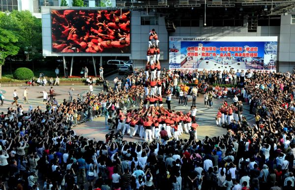 Performers from Spain stack themselves up during the Castell (means castle in Catalan) performance in the Nanjing Pedestrian Street of Shanghai, east China, May 23, 2010. The Castell performance, a traditional folk celebration in Catalonia of Spain, will also be shown in the Expo Park from May 24 to 30.