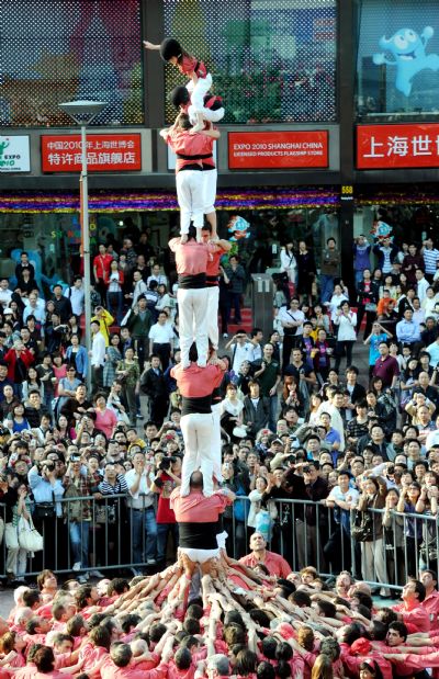 Performers from Spain stack themselves up during the Castell (means castle in Catalan) performance in the Nanjing Pedestrian Street of Shanghai, east China, May 23, 2010. The Castell performance, a traditional folk celebration in Catalonia of Spain, will also be shown in the Expo Park from May 24 to 30.