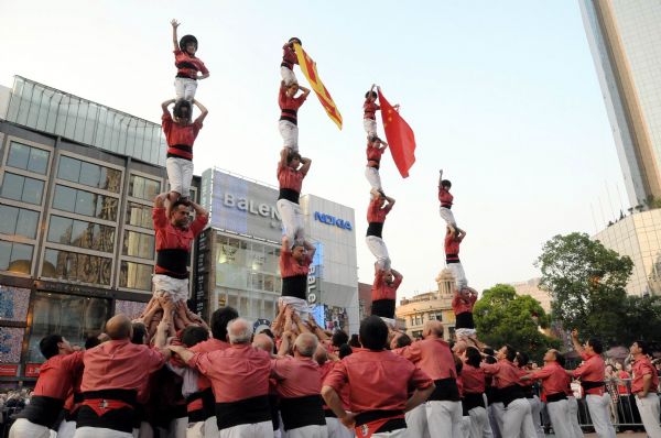 Performers from Spain stack themselves up during the Castell (means castle in Catalan) performance in the Nanjing Pedestrian Street of Shanghai, east China, May 23, 2010. The Castell performance, a traditional folk celebration in Catalonia of Spain, will also be shown in the Expo Park from May 24 to 30.