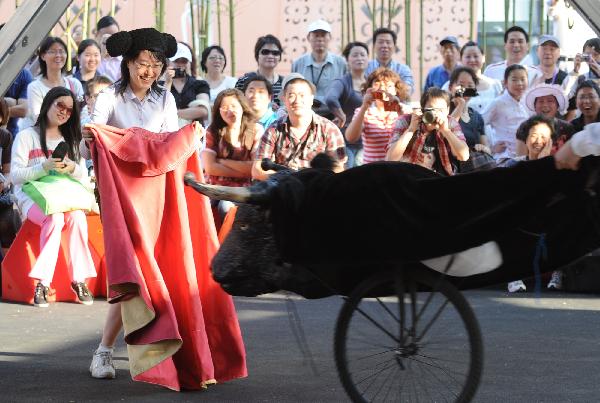 A tourist attends a bullfight interactive game at Madrid Pavilion in the Urban Best Practices Area (UBPA) in the World Expo Park in Shanghai, east China, May 24, 2010.