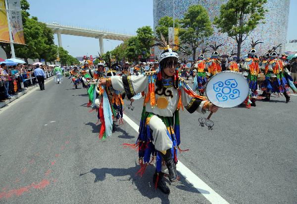 Drummers perform during a parade at the World Expo Park in Shanghai, east China, May 24, 2010. A grand parade named 'walking towards happiness' was held here Monday, the opening day of Inner Mongolia Week of the Shanghai World Expo, demonstrating the Inner Mongolia-related elements like Mongolian horses, Mongolian yurts to embody the cultural achievements of the Mongolia ethnic group. 