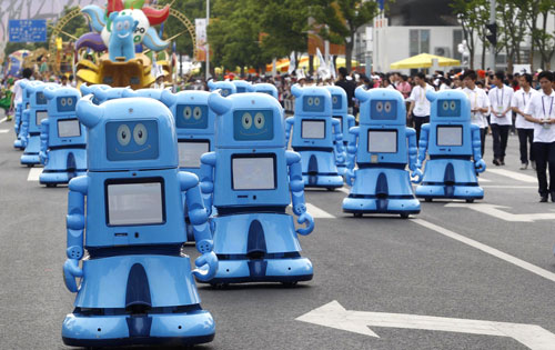 Haibao robots march in the Shanghai Expo Park, June 1, 2010. A total of 20 Expo mascot robots made up a team to walk in the Expo Park as Children's Day was celebrated there, attracting lots of visitors.