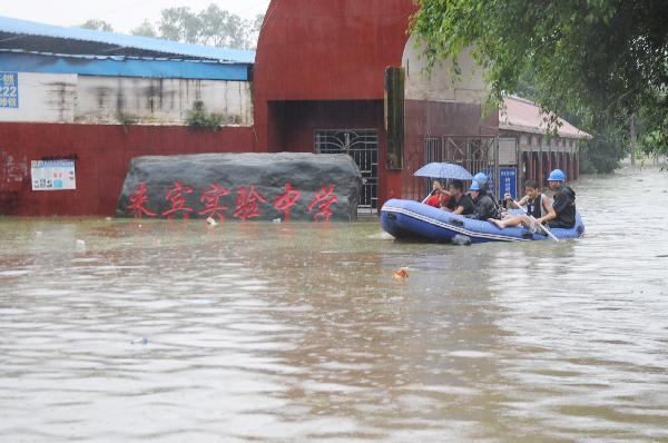 Rescuers using a lifeboat to rescue students trapped at the flooded campus of Laibin City Experimental Middle School in Laibin, southwest China&apos;s Guangxi Zhuang Autonomous Region, June 1, 2010.