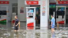 Local residents wade through a flooded street in Laibin City, southwest China's Guangxi Zhuang Autonomous Region, June 2, 2010. Laibin City was battered by heavy rain Monday night and Tuesday. The city center, the worst-hit by the rainstorm, received 439 mm of rainfall, an all-time high.