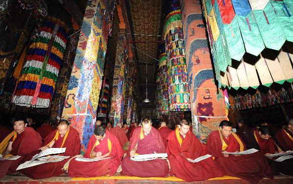 Monks pray for the victims of the earthquake that struck northwest China's Qinghai Province in April, exactly 49 days after the deaths, which according to Buddhist belief marks the start of the souls' reincarnation, during a prayer ritual in Taer (Gumbum) Monastery in northwest China's Qinghai Province, June 2, 2010.