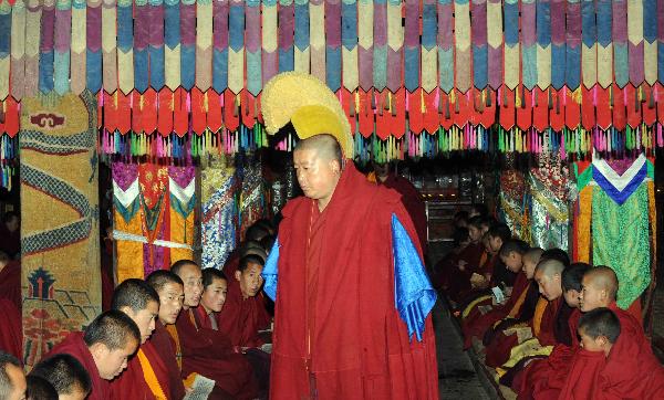 Monks pray for the victims of the earthquake that struck northwest China's Qinghai Province in April, exactly 49 days after the deaths, which according to Buddhist belief marks the start of the souls' reincarnation, during a prayer ritual in Taer (Gumbum) Monastery in northwest China's Qinghai Province, June 2, 2010.