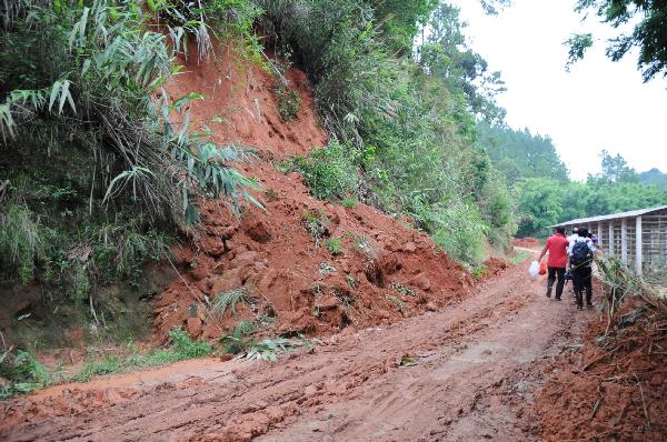Road is hit by landslides in Rongxian County of Yulin City, south China's Guangxi Zhuang Autonomous Region, June 2, 2010. 
