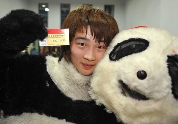 18-year-old Sun Cheng, 'Kung Fu Panda', poses with a China Pavilion ticket in hand after a show at the Shanghai Expo Park.