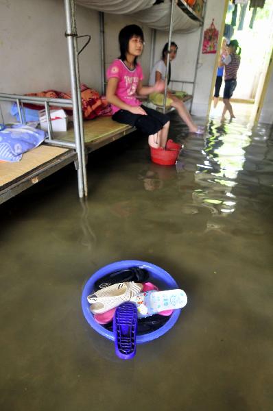 Students of grade 3 are seen at the flooded dormitory at the Second Senior High School in Yao Ethnic Autonomous County of Du'an in south China's Guangxi Zhuang Autonomous Region, June 2, 2010. 