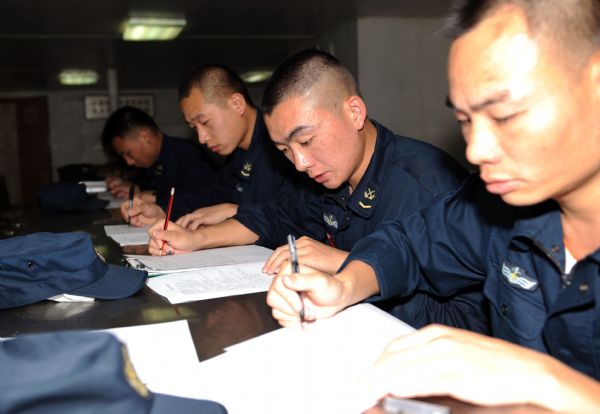 Signalmen of China's fifth escort flotilla to the Gulf of Aden attend a written examination during a communications training in the west of the Gulf of Aden June 3, 2010. 