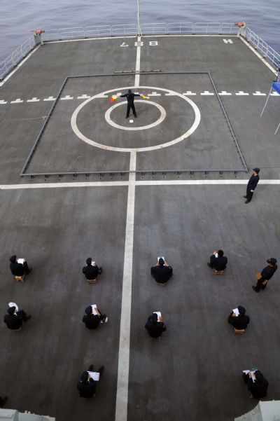 Signalmen of China's fifth escort flotilla to the Gulf of Aden attend a semaphore competition during a communications training in the west of the Gulf of Aden June 3, 2010. 