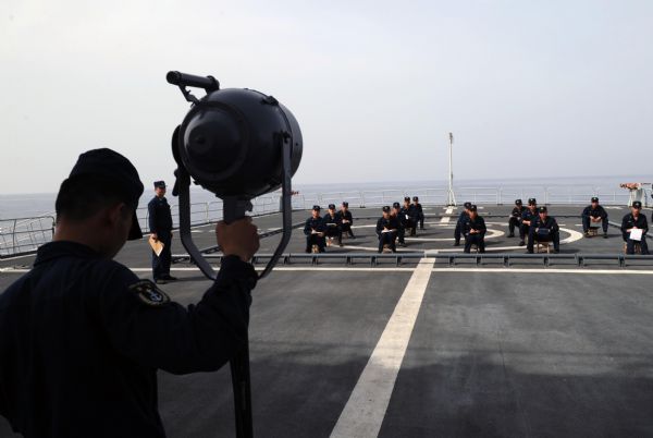 Signalmen of China's fifth escort flotilla to the Gulf of Aden attend a light signal competition during a communications training in the west of the Gulf of Aden June 3, 2010. 