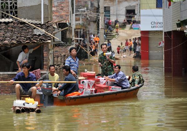 Local officers send relief supplies in Beigeng Township, Xincheng County, south China's Guangxi Zhuang Autonomous Region, June 3, 2010.