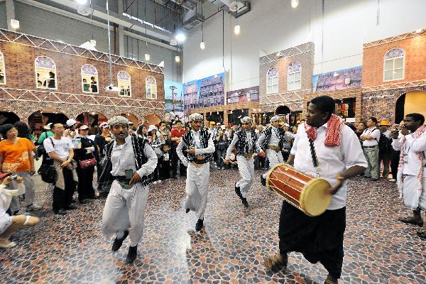 Yemeni performers dance along the drumbeat in Yemen Pavilion during the 2010 World Expo in Shanghai, east China, June 2, 2010. 