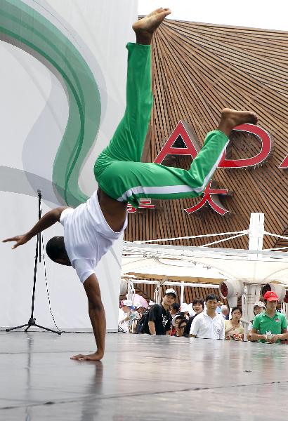 Actors perform Capoeira dance on the America Square during the national pavilion day of the Brazil Pavilion in the World Expo in Shanghai, east China, on June 3, 2010.