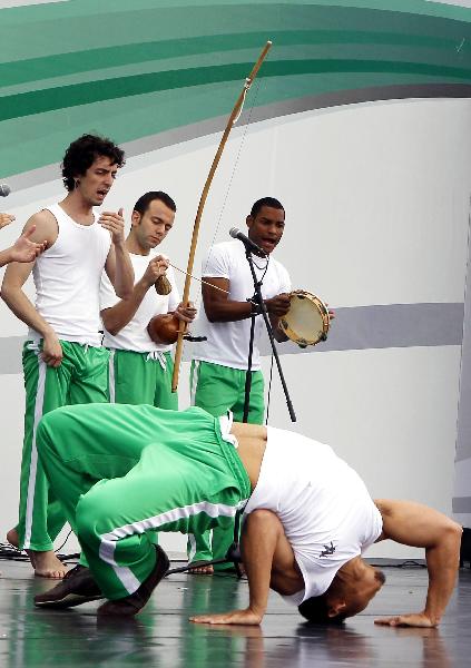 Actors perform Capoeira dance on the America Square during the national pavilion day of the Brazil Pavilion in the World Expo in Shanghai, east China, on June 3, 2010.