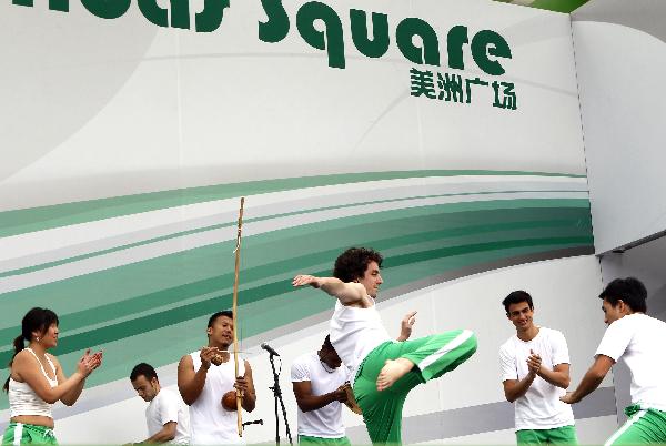 Actors perform Capoeira dance on the America Square during the national pavilion day of the Brazil Pavilion in the World Expo in Shanghai, east China, on June 3, 2010.