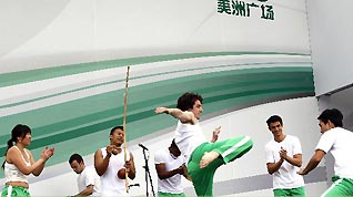 Actors perform Capoeira dance on the America Square during the national pavilion day of the Brazil Pavilion in the World Expo in Shanghai, east China, on June 3, 2010.
