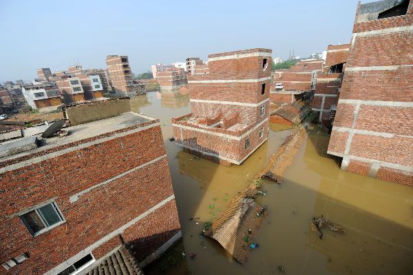 Houses are flooded at Lingwo, Dongshe district, Laibin city, south China&apos;s Guangxi Zhuang Autonomous Region, June 4, 2010. Some 1,700 residents in Lingwo were still trapped by the flood triggered by heavy rain since Wednesday in Guangxi.