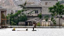 A resident rows a raft in Chengjiang Town of Yao Autonomous County of Du'an, southwest China's Guangxi Zhuang Autonomous Region, June 7, 2010.